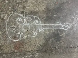 Guitarra dibujada con tiza.